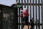 punjabis crossing US mexico border, entering US via mexico, video clip shows punjabi women children crossing border fence into u s, Punjabis