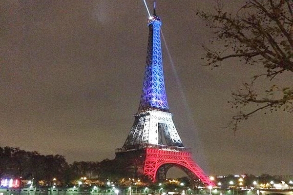 Eiffel Tower reopens, lit up with French flag colors },{Eiffel Tower reopens, lit up with French flag colors
